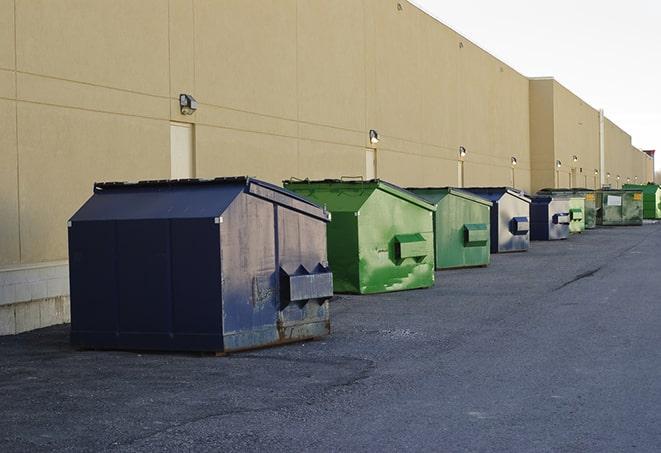 a group of dumpsters lined up along the street ready for use in a large-scale construction project in Pinole, CA